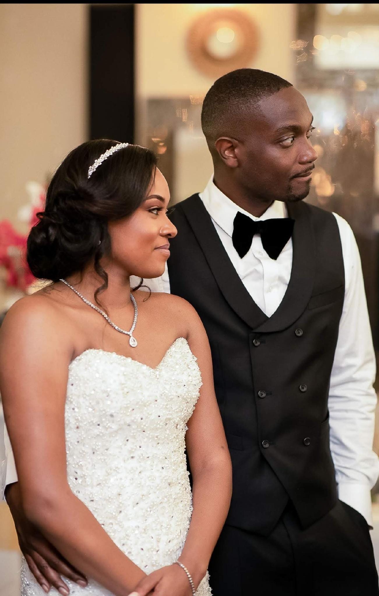 Bride and groom in black tuxedo vest and velvet bow tie